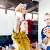 creative-business-people-writing-on-glass-wall-in-2024-10-18-03-36-17-utc